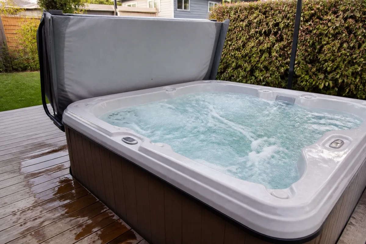 Hot tub jets running with splash water on the deck