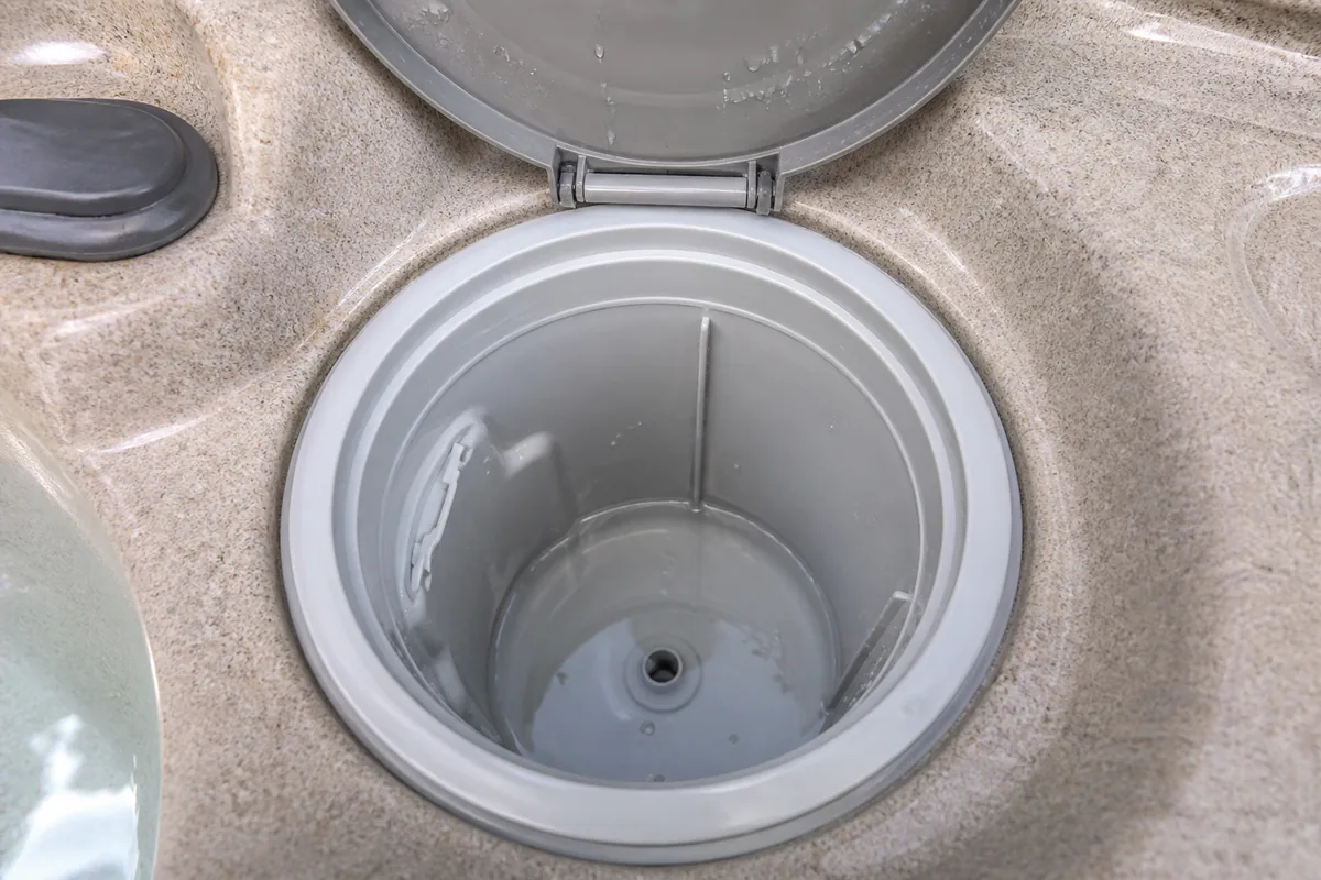 Open residential hot tub filter compartment with the cartridge removed